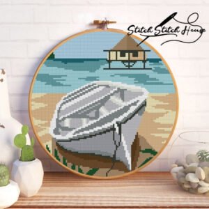 White boat on a tropical beach with a water villa cross stitch pattern design