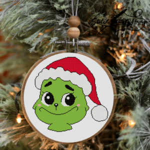 Cute Baby Grinch head with big eyes wearing a Santa hat handmade cross stitch pattern design